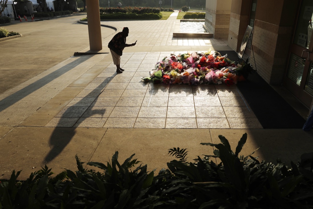 A woman stops to photograph a memorial for George Floyd at The Fountain of Praise church in Houston, Tuesday, June 9, 2020, in Houston. (AP Photo/Eric Gay)