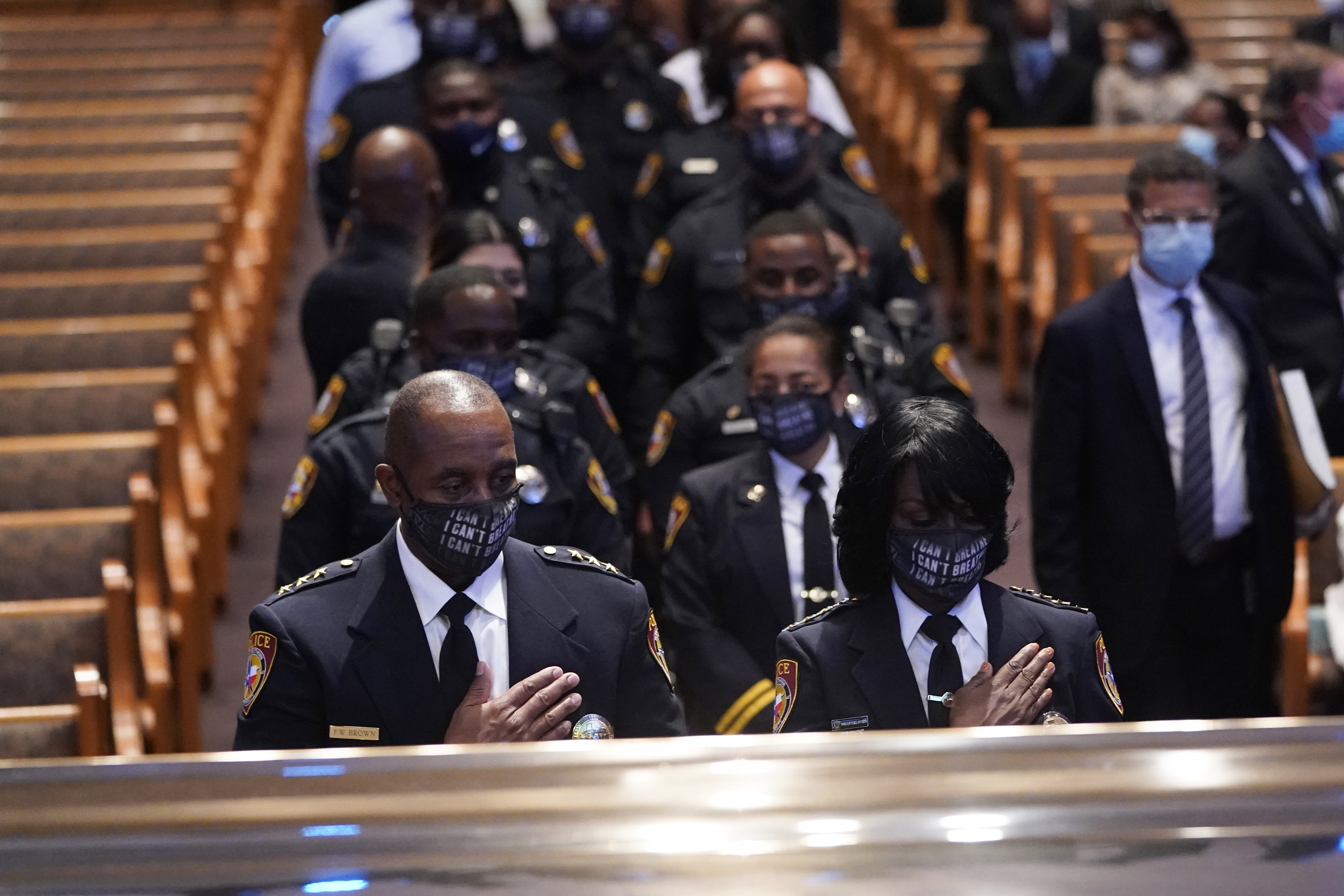 Members of the Texas Southern University police department pause during a funeral service for George Floyd at The Fountain of Praise church Tuesday, June 9, 2020, in Houston. (AP Photo/David J. Phillip, Pool)