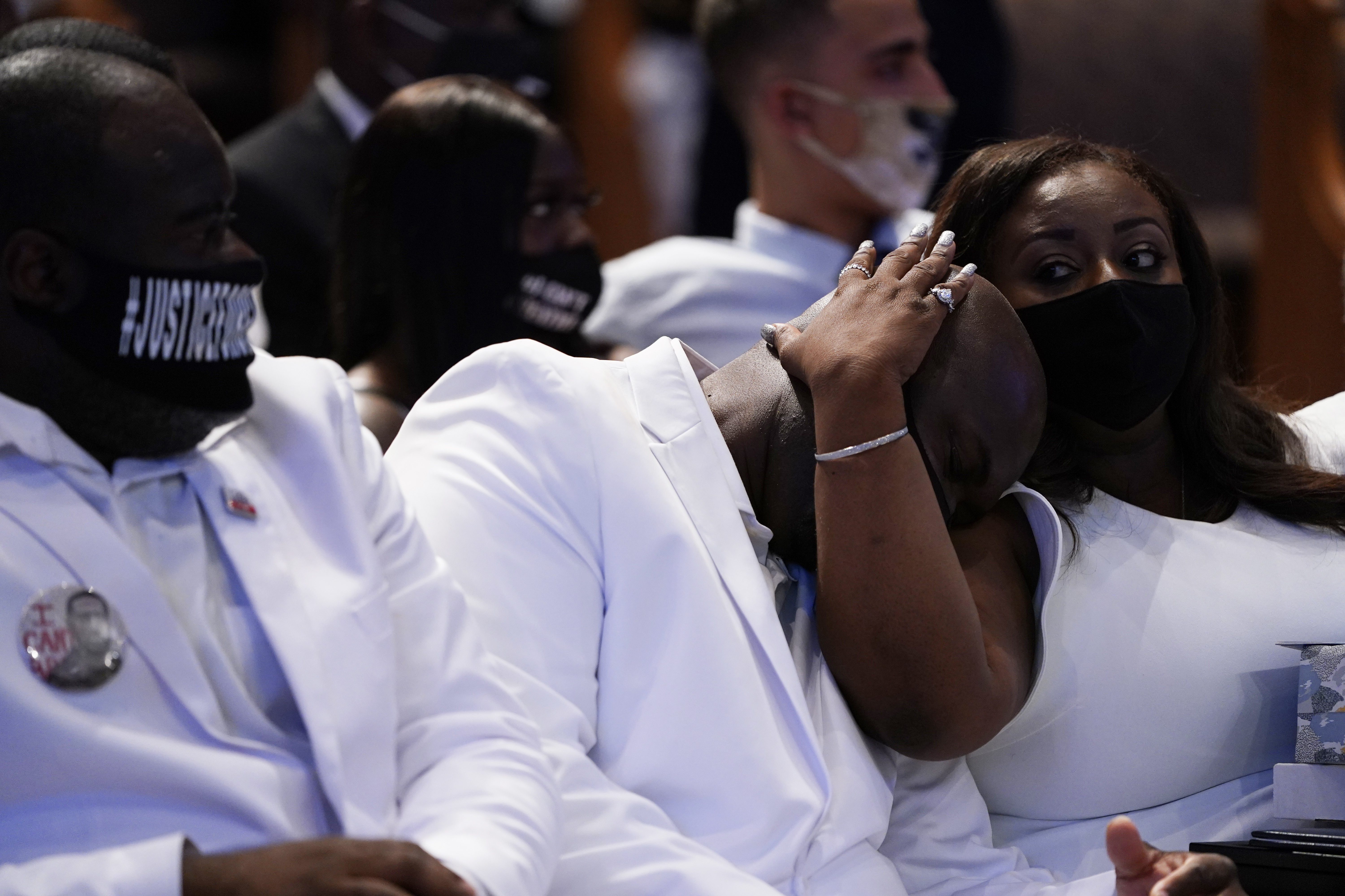 Philonise Floyd, center is comforted during the funeral service for George Floyd at The Fountain of Praise church Tuesday, June 9, 2020, in Houston. (AP Photo/David J. Phillip, Pool)