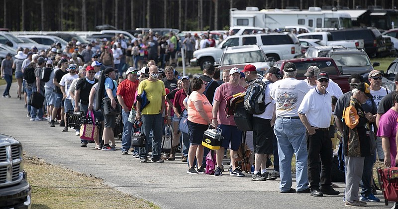 AP photo by Robert Willett / Hundreds of auto racing fans wait in line to purchase tickets May 23 at Ace Speedway near Elon, N.C.