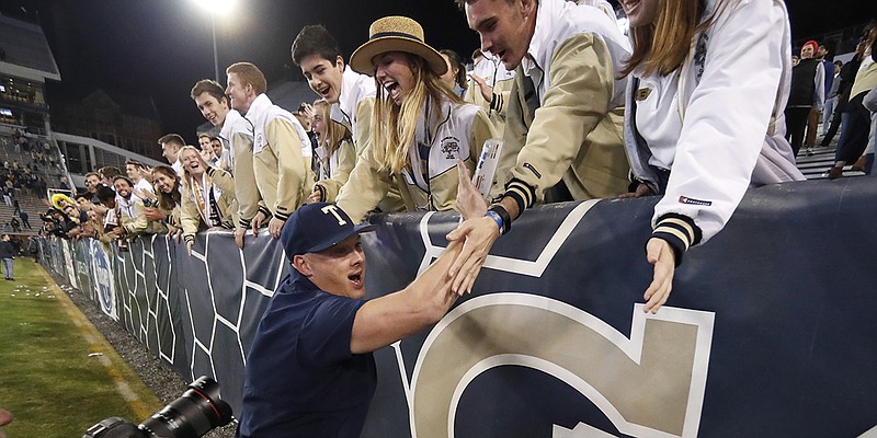 AP photo by John Bazemore / Georgia Tech football coach Geoff Collins celebrates with fans after the Yellow Jackets beat North Carolina State 28-26 in an ACC matchup on Nov. 21, 2019, at Grant Field at Bobby Dodd Stadium in Atlanta.