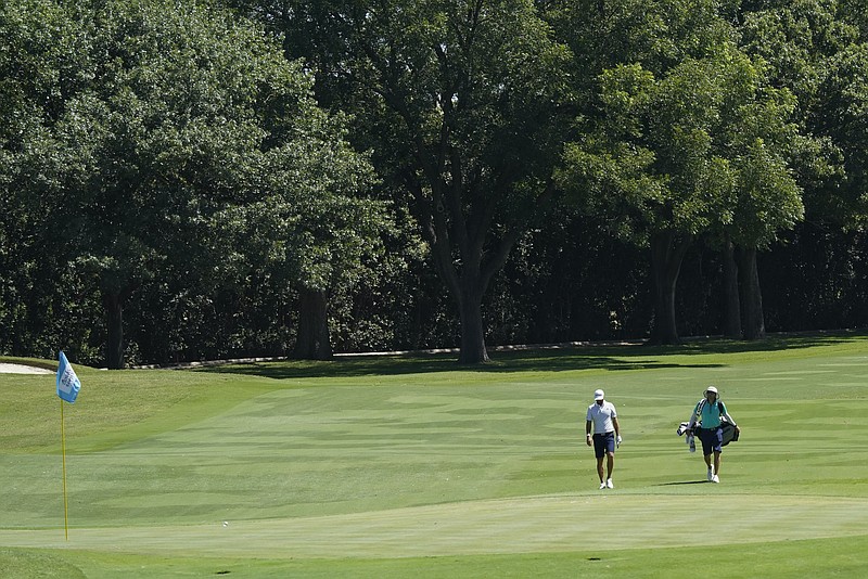 AP photo by David J. Phillip / Dustin Johnson walks to the 12th green at Colonial Country Club during Wednesday's practice for the Charles Schwab Challenge in Fort Worth, Texas. The tournament, which starts Thursday, is the PGA Tour's first since The Players Championship was canceled after one round in mid-March as the coronavirus outbreak shut down organized sports.