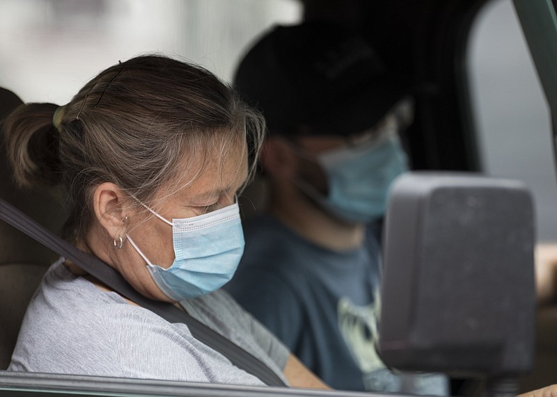 Staff photo by Troy Stolt / Iris and Trevor Pyke wait in line so that Trevor can be tested for COVID-19 at a pop-up test site at the New Hope Baptist Church by Cempa Community care on Wednesday, May 27, 2020 in Chattanooga, Tenn.