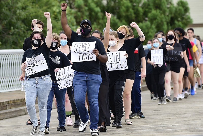 Staff Photo by Robin Rudd / Emily Stoddard, of East Ridge High School, and Jordon Austin, of Red Bank High School lead a Monday march across the Walnut Street Bridge to Coolidge Park. High School students and others organized the protest after the death of George Floyd in Minneapolis and the maltreatment of others by police and authorities.