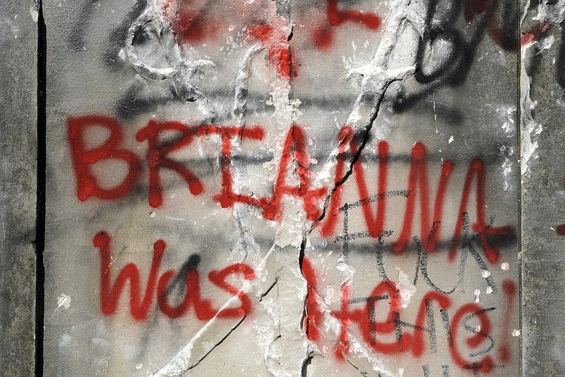 Graffiti is show on the damaged base of a Confederate memorial that was removed overnight in Birmingham, Ala., on Tuesday, June 2, 2020. The city took down the more than 50-foot-tall obelisk following protests over the police death of George Floyd and a night of vandalism in the city. Demonstrators used rocks, hammers and paint to deface the monument. (AP Photo/Jay Reeves)


