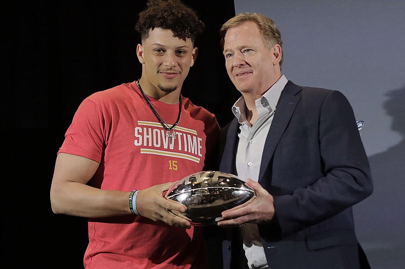 AP photo by Brynn Anderson / Kansas City Chiefs quarterback Patrick Mahomes, left, holds the MVP trophy from Super Bowl LIV with NFL commissioner Roger Goodell before speaking at a news conference in Miami on Feb. 3.