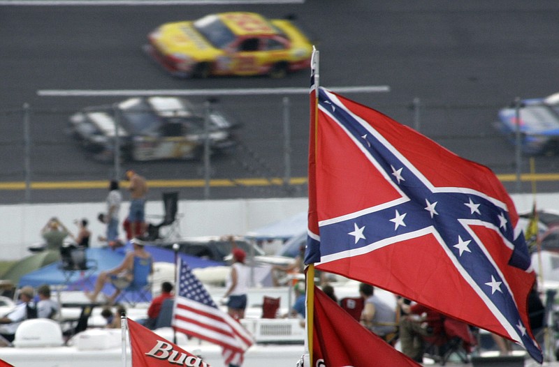 The Associated Press file photo / In this Oct. 7, 2007 photo, a Confederate flag flies in the infield as cars roar by during a NASCAR auto race at Talladega Superspeedway in Talladega, Ala. NASCAR is banning confederate flags at its races in the aftermath of protests over the death of George Floyd under the knee of a police officer in Minneapolis.