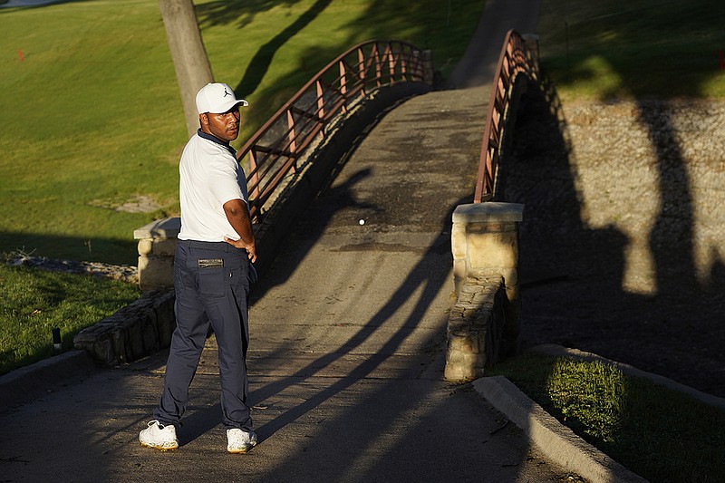 AP photo by David J. Phillip / Harold Varner III examines his golf ball that landed on a bridge after his tee shot on the 10th hole at Colonial Country Club during the second round of the Charles Schwab Challenge on Friday in Fort Worth, Texas.