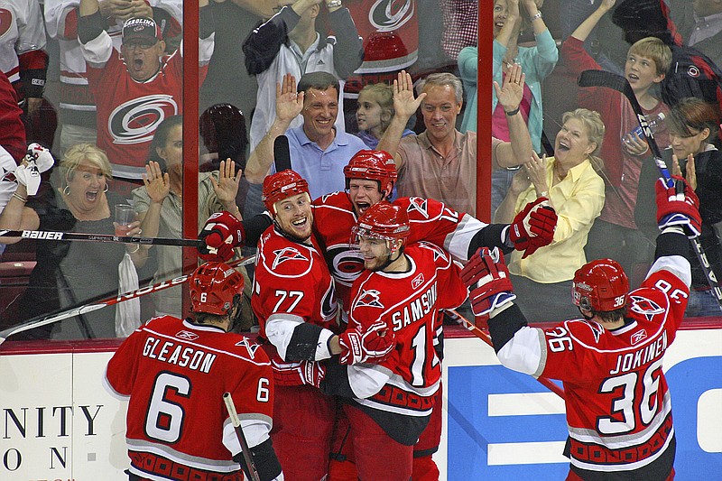 AP photo by Karl B. DeBlaker / Carolina players hug as they celebrate a Hurricanes goal against the Boston Bruins during postseason matchup on May 8, 2009, in Raleigh, N.C. NHL players have been allowed back at their team's facilities for the better part of a week, but that doesn't mean they can do much in the way of close contact or working together.