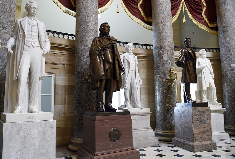 FILE - In this June 24, 2015 file photo, a statue of Jefferson Davis, second from left, president of the Confederate States from 1861 to 1865, is on display in Statuary Hall on Capitol Hill in Washington. House Speaker Nancy Pelosi is demanding that statues of Confederate figures such as Jefferson Davis be removed from the U.S. Capitol. (AP Photo/Susan Walsh, File)


