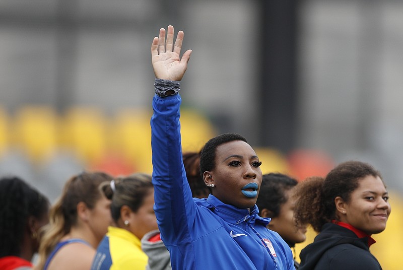 AP photo by Rebecca Blackwell / U.S. track and field team member Gwen Berry waves as she is introduced at the start of the women's hammer throw final at the Pan American Games on Aug. 10, 2019, in Lima, Peru. Berry won the gold medal.