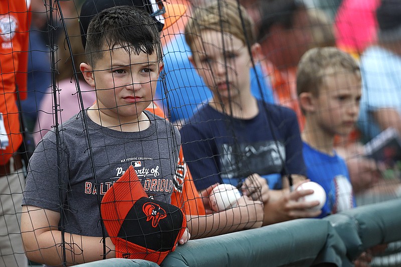 AP photo by Elise Amendola / Young baseball fans seeking autographs react with disappointment after being told by a player he couldn't sign prior to a spring training game between the Baltimore Orioles and the Atlanta Braves on March 10 in Sarasota, Fla.