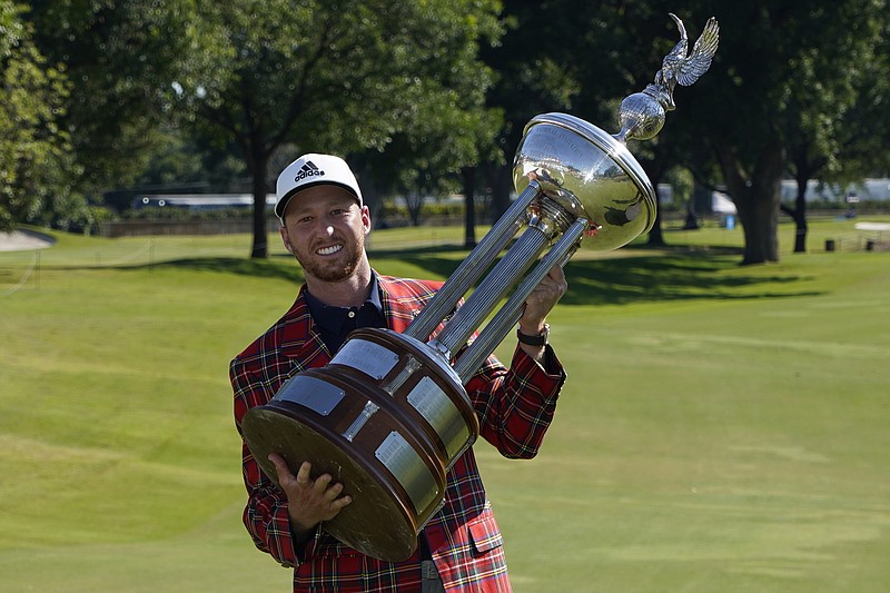 AP photo by David J. Phillip / Daniel Berger poses with the championship trophy after winning the PGA Tour's Charles Schwab Challenge in a playoff against Collin Morikawa on Sunday afternoon at Colonial Country Club in Fort Worth, Texas.