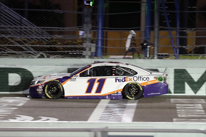 AP photo by Wilfredo Lee / Denny Hamlin crosses the finish line to win Sunday's NASCAR Cup Series race in Homestead, Fla.