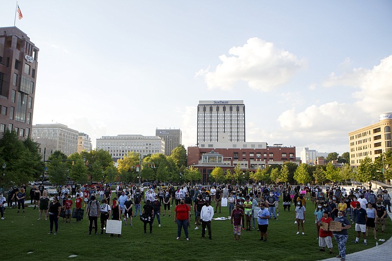 Staff photo by C.B. Schmelter / Protestors take part in a breathing exercise at Miller Park while protesting the killing of George Floyd on Monday, June 1, 2020 in Chattanooga, Tenn. Floyd, 46, died after being handcuffed and pinned for several minutes beneath Minneapolis police Officer Derek Chauvin's knee. Protests entered their third night in Chattanooga.