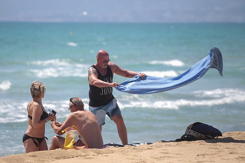 German tourists arrive at the beach of Palma de Mallorca, Spain, Monday, June 15, 2020. Borders opened up across Europe on Monday after three months of coronavirus closures that began chaotically in March. But many restrictions persist, it's unclear how keen Europeans will be to travel this summer and the continent is still closed to Americans, Asians and other international tourists. (AP Photo/Joan Mateu)


