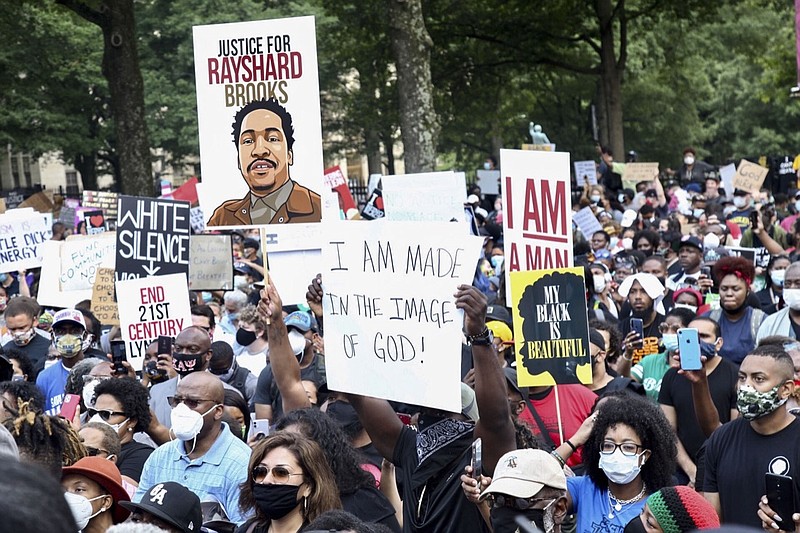 A crowd of demonstrators march to the Capitol Monday, June 15, 2020 in Atlanta. The NAACP March to the Capitol coincided with the restart of the Georgia 2020 General Assembly. Lawmakers returned wearing masks and followed new rules to restart the session during the pandemic. (Steve Schaefer/Atlanta Journal-Constitution via AP)