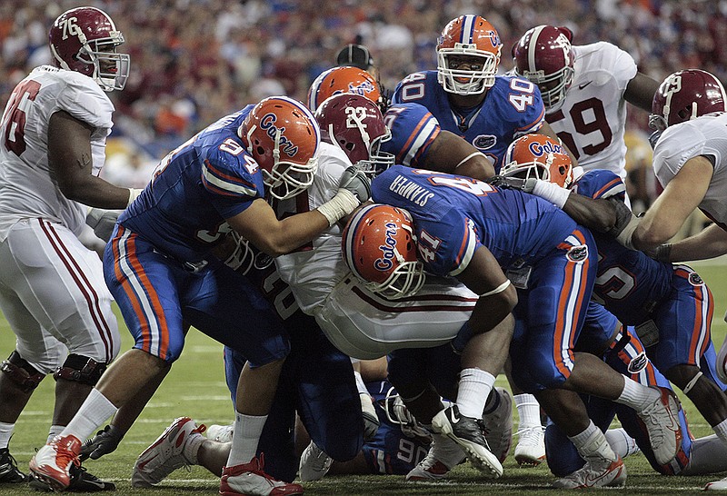 AP photo by Dave Martin / A tenacious Florida defense holds Alabama running back Mark Ingram (22) for no gain during the SEC title game on Dec. 6, 2008 at the Georgia Dome.
