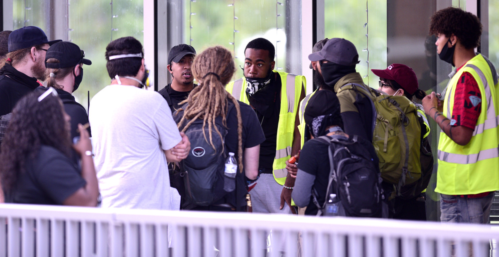 Staff Photo by Robin Rudd / Officials meet before the start of the march. Protesters gathered at Miller Park and marched south past some of Chattanooga's tourism icons in reaction to the killing of George Floyd and other police brutalities on June 17, 2020.