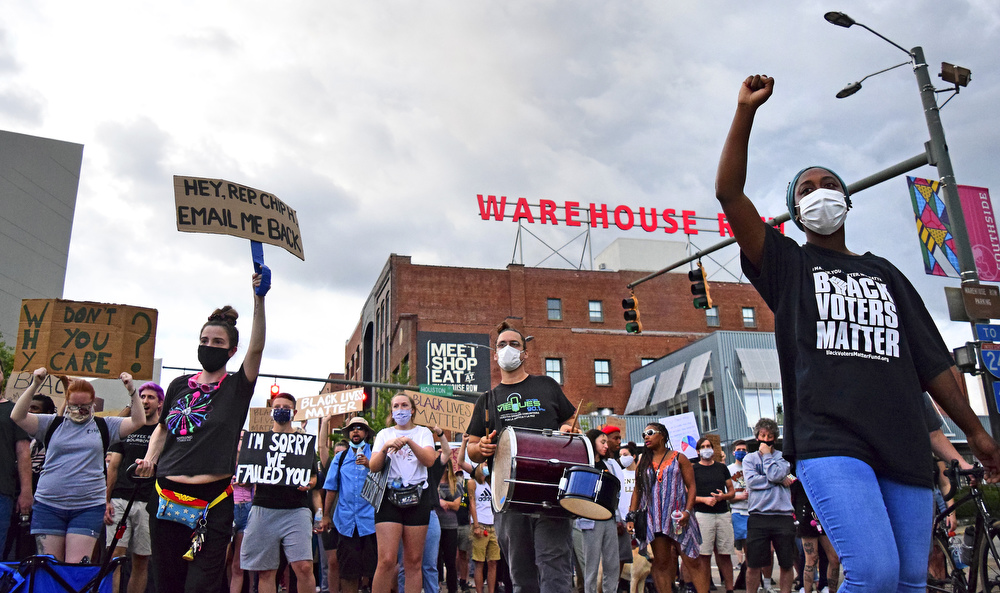 Staff Photo by Robin Rudd / After a brief pause at the intersection of Houston and Market Streets the march resumes going south toward the Choo Choo. Protesters gathered at Miller Park and marched south past some of Chattanooga's tourism icons in reaction to the killing of George Floyd and other police brutalities on June 17, 2020.