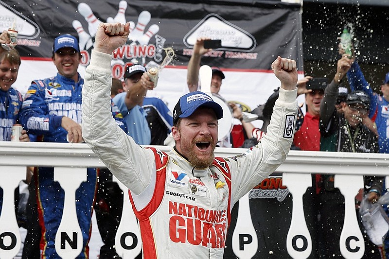 FILE - In this Aug. 3, 2014, file photo, Dale Earnhardt Jr. celebrates in Victory Lane after winning a NASCAR Sprint Cup Series auto race at Pocono Raceway in Long Pond, Pa. Longtime fan favorite Dale Earnhardt Jr. is expected to be the marquee name on NASCAR's 2021 Hall of Fame class, to be announced Tuesday, June 16, 2020. (AP Photo/Matt Slocum, File)