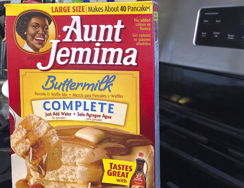A box of Aunt Jemima pancake mix sits on a stovetop Wednesday, June 17, 2020, in Harrison, N.Y. Pepsico is changing the name and marketing image of its Aunt Jemima pancake mix and syrup, according to media reports. A spokeswoman for Pepsico-owned Quaker Oats Company told AdWeek that it recognized Aunt Jemima's origins are based on a racial stereotype and that the 131-year-old name and image would be replaced on products and advertising by the fourth quarter of 2020. Quaker did not say what the name would be changed to. (AP Photo/Courtney Dittmar)