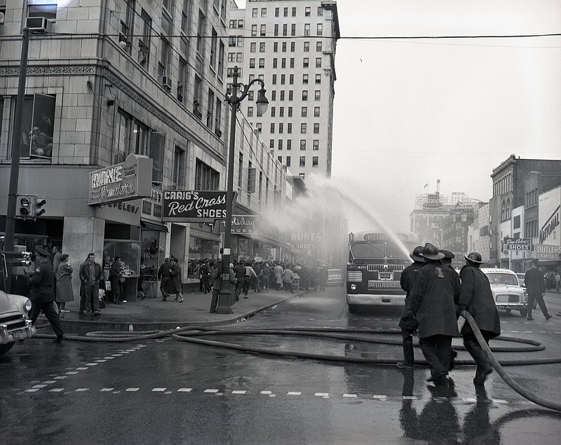 Chattanooga firefighters turn fire hoses on demonstrators outside the F.W. Woolworth Co. store on Market Street in February 1960. Photo from the Chattanooga Free Press collection at ChattanoogaHistory.com.