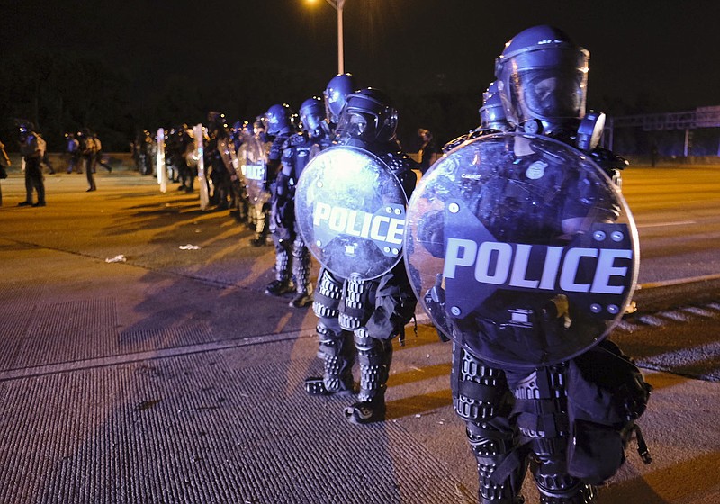 Photo by Ben Gray of the Atlanta Journal-Constitution via The Associated Press / After demonstrators got onto I-75 and shut down the interstate, police line up in riot gear in Atlanta on Saturday, June 13, 2020. Demonstrators were protesting the death of Rayshard Brooks, a black man who was shot and killed by Atlanta police following a struggle in a Wendy's drive-thru line.