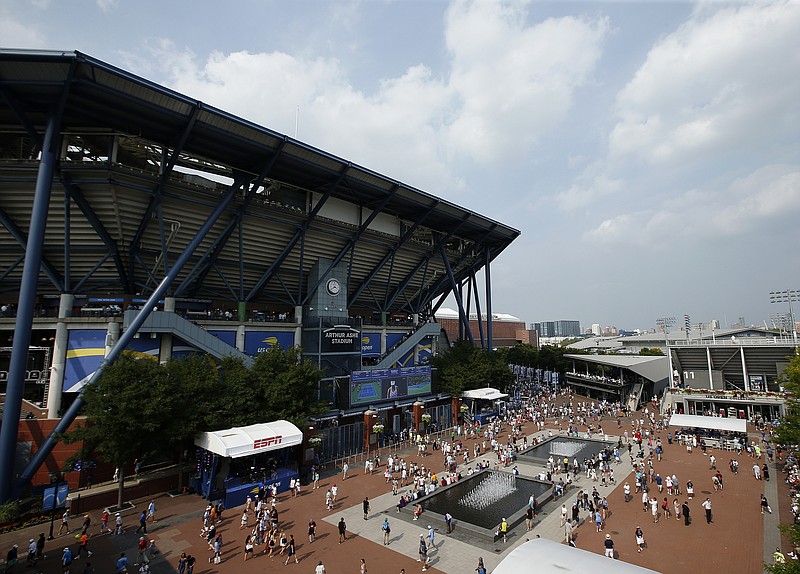 AP photo by Jason DeCrow / Fans walk outside of Arthur Ashe Stadium during the first round of the U.S. Open tennis tournament on Aug. 27, 2018, in New York.