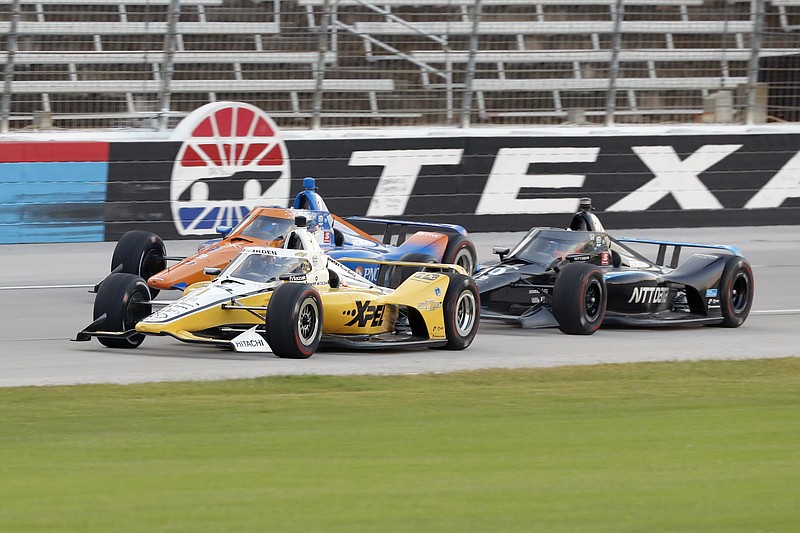 AP photo by Tony Gutierrez / IndyCar drivers Josef Newgarden, front, Scott Dixon, rear, and Felix Rosenqvist, right, race down the front stretch at Texas Motor Speedway on June 6 in Fort Worth.