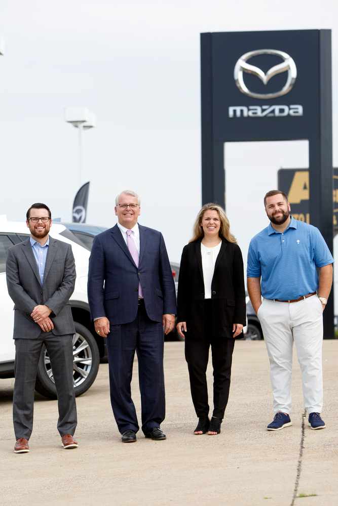 Staff photo by C.B. Schmelter / Jesse Morgan, left, Brent Morgan, Abigail Lockhart and Bailey Morgan stand at the Mazda dealership off International Drive which Integrity Automotive Group recently acquired. Jesse, Abigail and Bailey are vice presidents and Brent is president of the Chattanooga auto group.