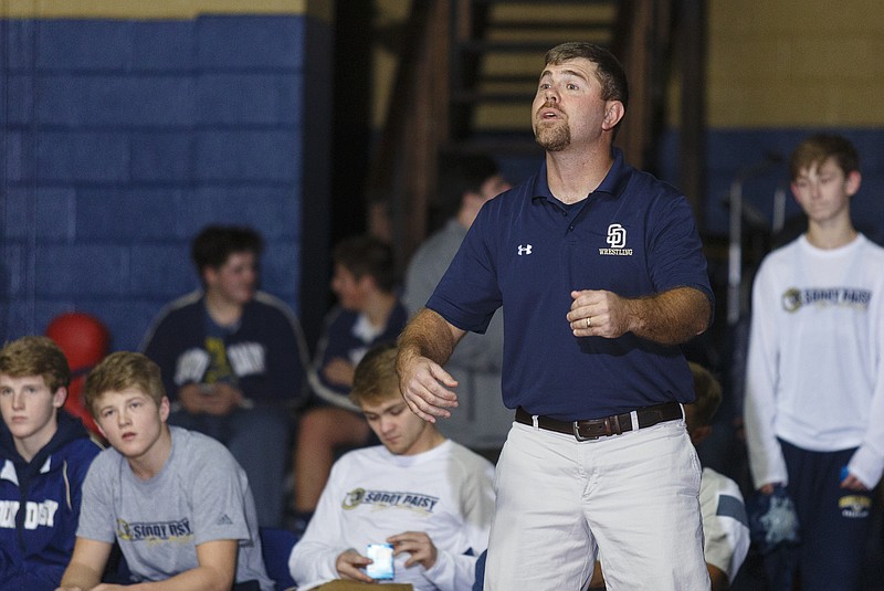 Staff photo / Jim Higgins coaches the Soddy-Daisy wrestling team during a home match in December 2016. Higgins, who stepped down as wrestling coach in 2018 but then took over the school's baseball program, formed a special bond with Hayden Maynor, second from left. Maynor, who graduated this spring, was a standout for the Trojans in baseball, football and wrestling — the same three sports that Higgins, a 1998 Soddy-Daisy graduate, played during high school.