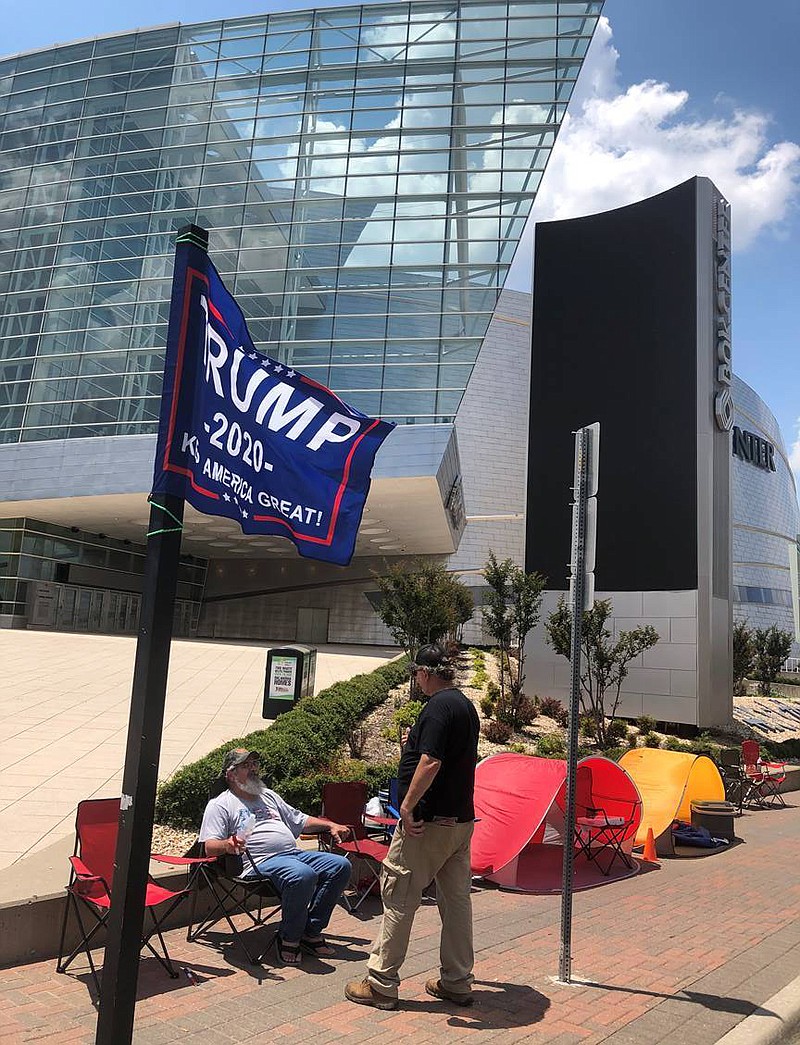AP Photo, Tom McCarthy / James Massery, left, of Preston, Okla., and Daniel Hedman, of Tulsa, Okla., supporters of President Donald Trump, camp outside the BOK Center in Tulsa on Tuesday, four days before his scheduled rally Saturday.