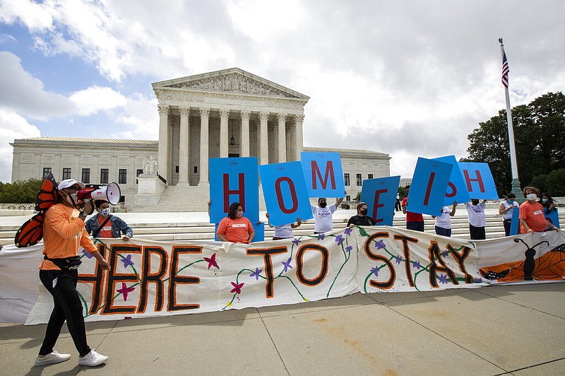 Deferred Action for Childhood Arrivals (DACA) recipient Roberto Martinez, left, celebrates with other DACA recipients in front of the Supreme Court on Thursday, June 18, 2020, in Washington. The Supreme Court on Thursday rejected President Donald Trump's effort to end legal protections for 650,000 young immigrants, a stunning rebuke to the president in the midst of his reelection campaign. (AP Photo/Manuel Balce Ceneta)