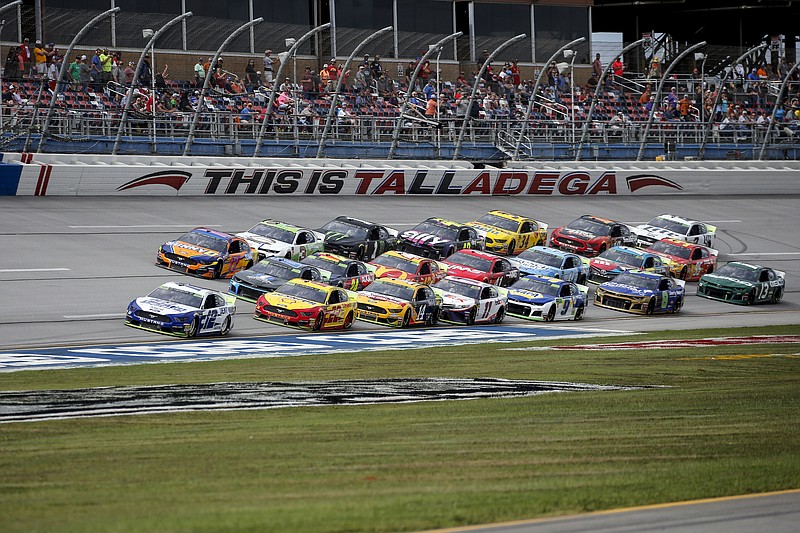 AP photo by Butch Dill / Ryan Blaney (12) leads a pack of cars through the tri-oval during a NASCAR Cup Series race on Oct 14, 2019, at Talladega Superspeedway in Alabama.