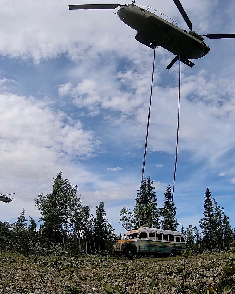 In this photo released by the Alaska National Guard, Alaska Army National Guard soldiers use a CH-47 Chinook helicopter to removed an abandoned bus, popularized by the book and movie "Into the Wild," out of its location in the Alaska backcountry Thursday, June 18, 2020, as part of a training mission. Alaska Natural Resources Commissioner Corri Feige, in a release, said the bus will be kept in a secure location while her department weighs various options for what to do with it. (Sgt. Seth LaCount/Alaska National Guard via AP)
