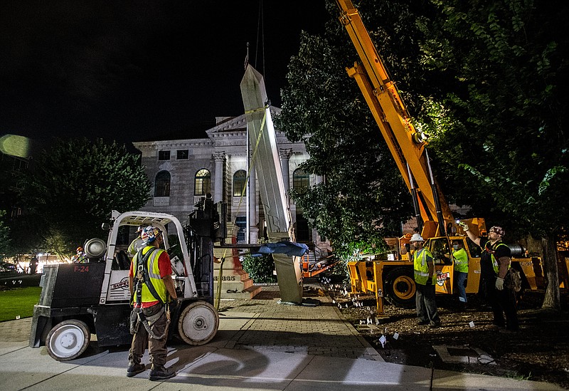 Workers remove a Confederate monument with a crane Thursday, June 18, 2020, in Decatur, Ga. The 30-foot obelisk in Decatur Square, erected by the United Daughters of the Confederacy in 1908, was ordered by a judge to be removed and placed into storage indefinitely. (AP Photo/Ron Harris)


