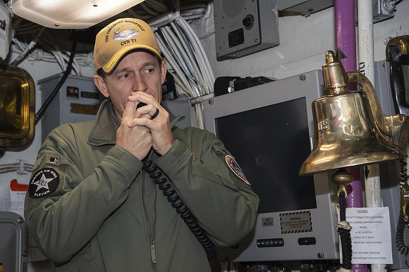 In this image provided by the U.S. Navy, Capt. Brett Crozier, then-commanding officer of the aircraft carrier USS Theodore Roosevelt (CVN 71), addresses the crew on Jan. 17, 2020, in San Diego, Calif. In a stunning reversal, the Navy has upheld the firing of Crozier, the aircraft carrier captain who urged faster action to protect his crew from a coronavirus outbreak, according to a U.S. official. (Mass Communication Specialist Seaman Alexander Williams/U.S. Navy via AP)


