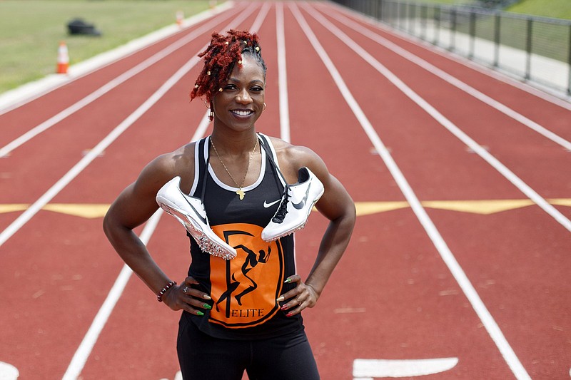 Staff photo by C.B. Schmelter / LaQuisha Jackson poses Tuesday on the track at Brainerd High School. Jackson was a star sprinter in high school for Howard before going on to a record-setting collegiate career at San Diego State and Missouri. Now she's back in Chattanooga and training for what she hopes will be a second trip to the U.S. Olympic team trials, with her ultimate goal to run next summer at the rescheduled Tokyo Games.
