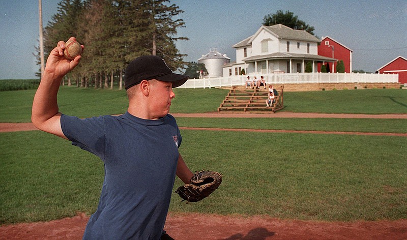 AP photo by Kevin Wolf / Chris Brandt, of Worthington, Minn., pitches from the mound on the baseball field at the filming site of the 1989 move "Field of Dreams" during a family vacation on July 17, 1996.