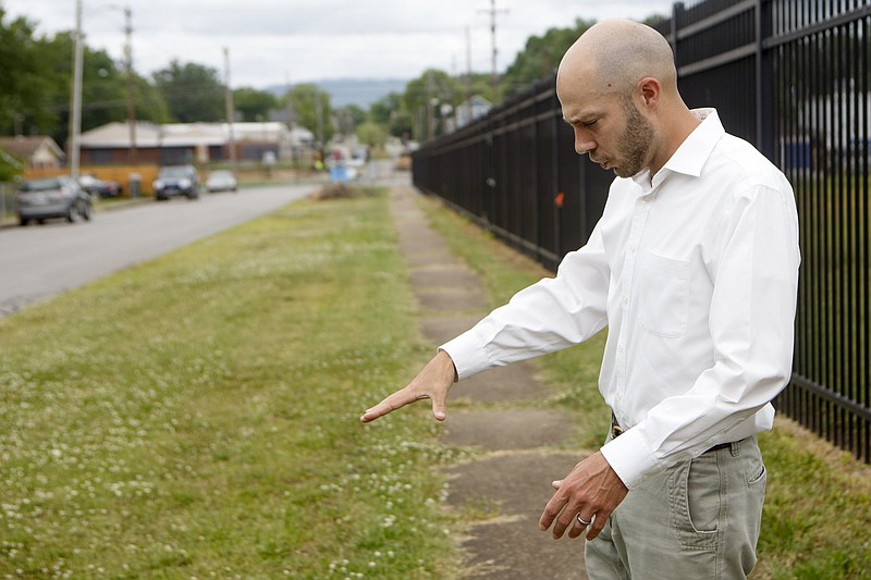 Staff photo by C.B. Schmelter / Matt Lyle gestures at the site of an old railroad line in Highland Park that could be part of a 7-mile pedestrian link running from downtown to East Lake called the East Line.