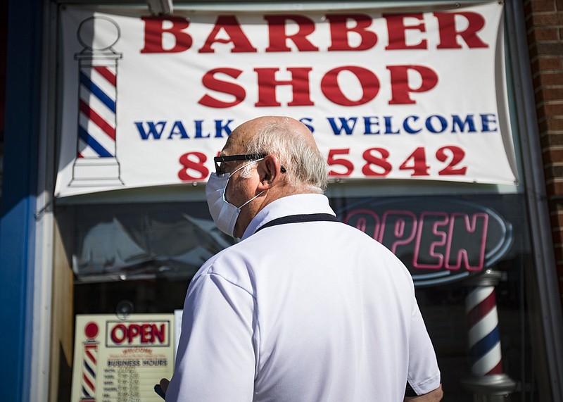 Staff photo by Troy Stolt / John Westbrook waits outside of Hixson Barber Shop on Wednesday, May 6, 2020 in Hixson, Tenn.