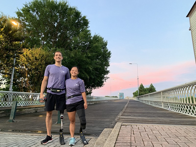 Staff photo by Patrick MacCoon / Ronnie Dickson and Mariah Berner get ready to begin their half marathon run from the Walnut Street Bridge in downtown Chattanooga on Saturday morning.