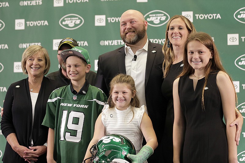 AP photo by Seth Wenig / New York Jets general manager Joe Douglas, center, poses for a picture with his family during a news conference at the team's training facility on June 11, 2019, in Florham Park, N.J.