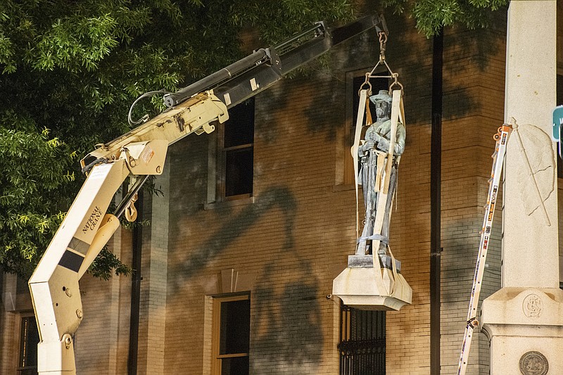 Photo from the Pitt County Public Information Office via The Associated Press / This photo shows the removal of a Confederate statue in Greenville, North Carolina, on Monday, June 22, 2020. Crews on Monday removed the bronze statue that tops the monument outside the Pitt County Courthouse in Greenville.