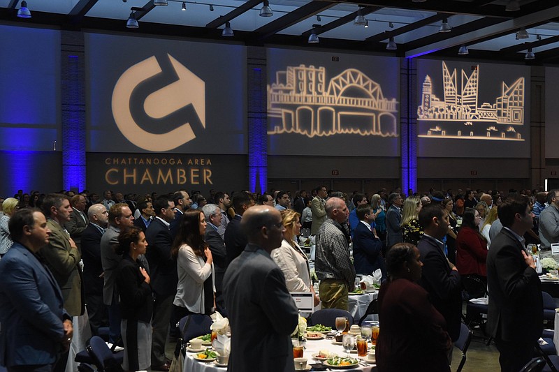 Staff photo by Tim Barber/ Hundreds of attendees stand at the outset of the Chattanooga Area Chamber of Commerce Annual Meeting last year at the Chattanooga Convention Center. The Chamber's annual meeting this year will be entirely online.