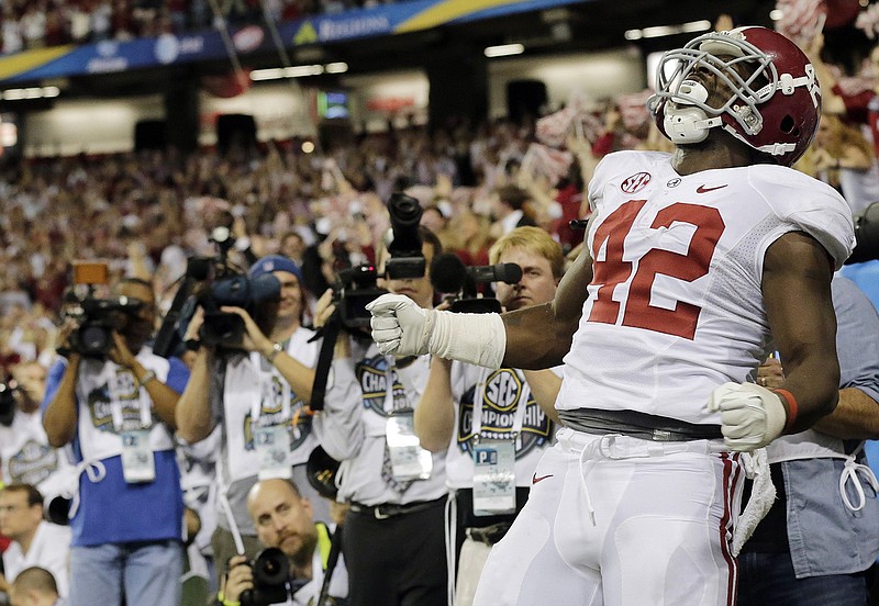 AP photo by Dave Martin / Alabama running back Eddie Lacy celebrates after scoring a touchdown against Georgia during the first half of the SEC football championship game on Dec. 1, 2012, at the Georgia Dome in Atlanta.