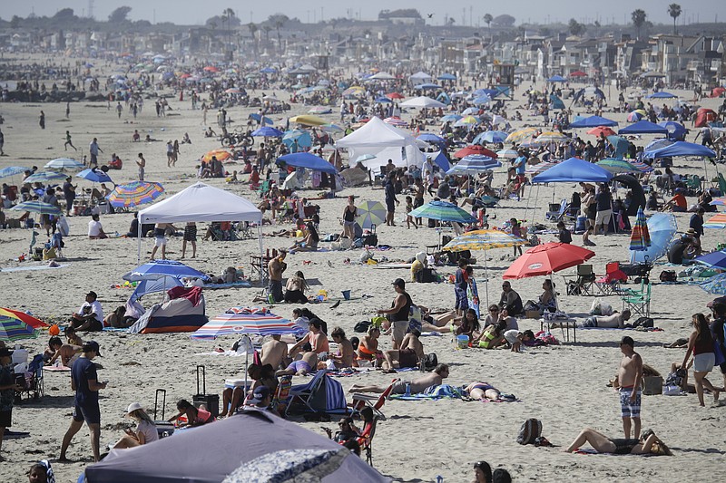 FILE - In this May 24, 2020, file photo, visitors gather on the beach in Newport Beach, Calif., during the coronavirus outbreak. Warm weather beach destinations are the most popular vacation searches, with Florida, Myrtle Beach, San Diego and Key West among the top considerations. (AP Photo/Marcio Jose Sanchez, File)


