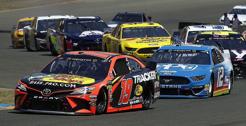 AP photo by Ben Margot / Martin Truex Jr. leads the pack through a turn during a NASCAR Cup Series auto race on June 23, 2019, in Sonoma, Calif.