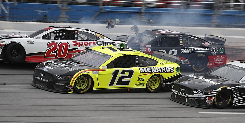 AP photo by John Bazemore / Ryan Blaney (12) approaches the finish line on his way to victory as Erik Jones (20) crashes at the end of Monday's NASCAR Cup Series race at Talladega Superspeedway in Alabama.